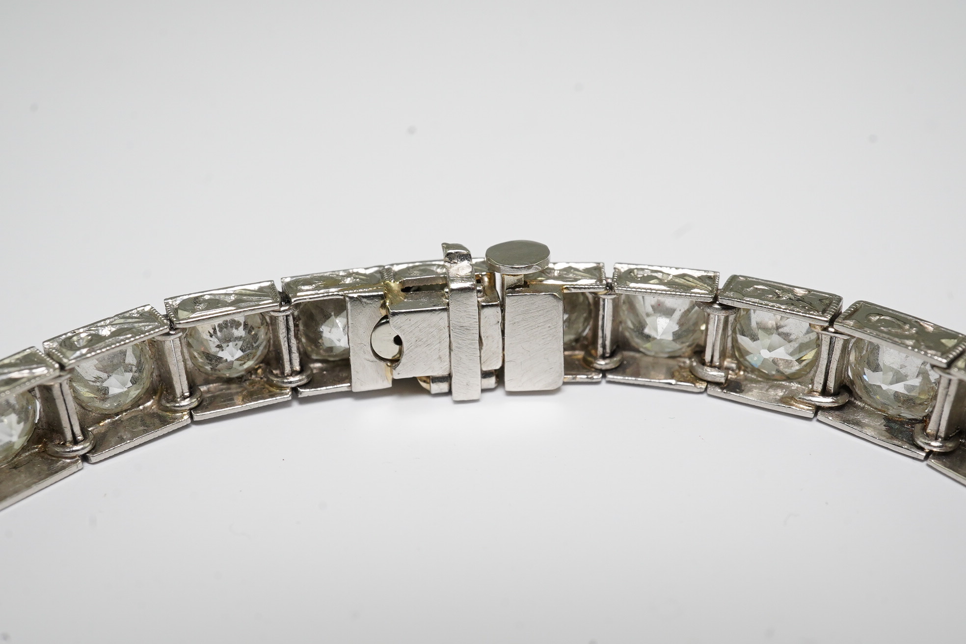 A platinum and thirty one stone round cut diamond set line bracelet